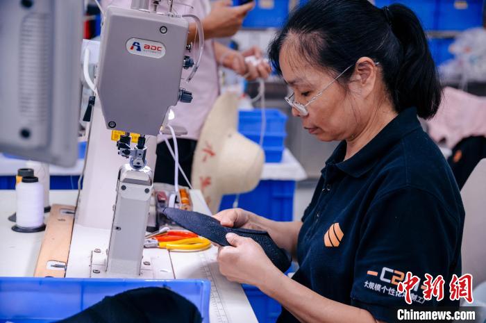 圖為員工在生產(chǎn)線工作?！±钅宪?攝